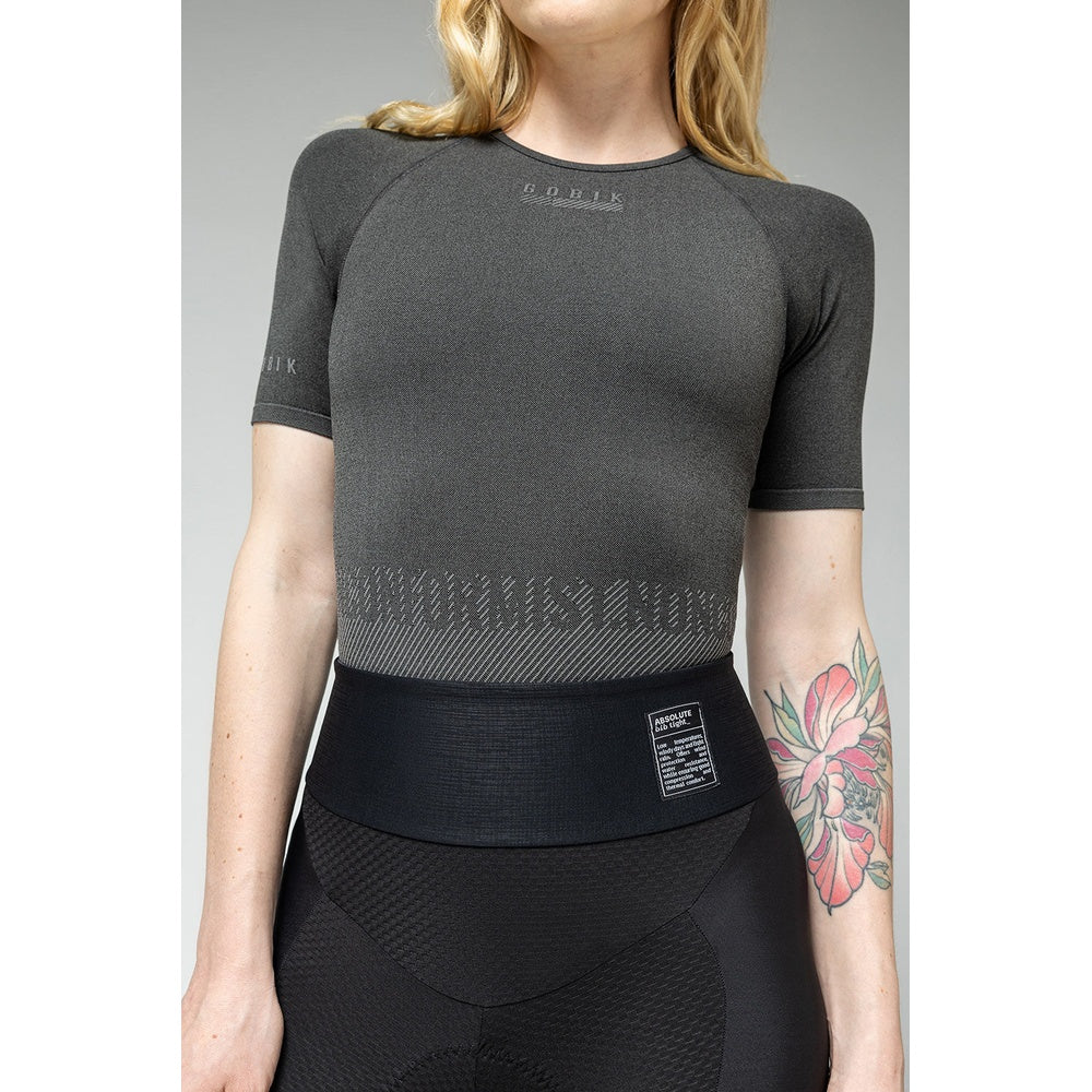 Woman wearing Gobik grey base layer top with textured pattern and black athletic wear