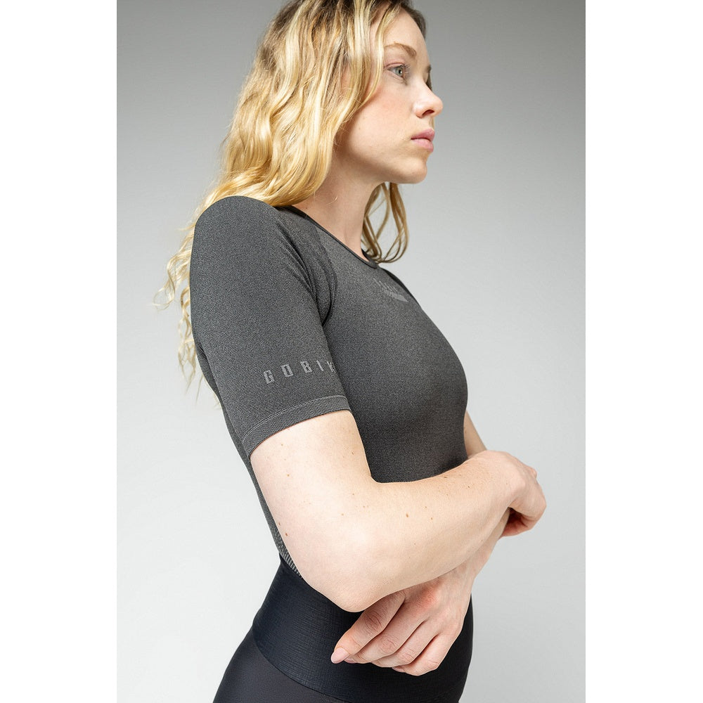 Woman wearing Gobik charcoal gray base layer top in profile view