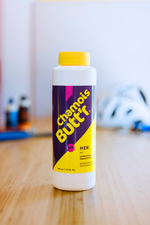 Chamois Butt'r HER anti-chafe cream bottle with purple and yellow label