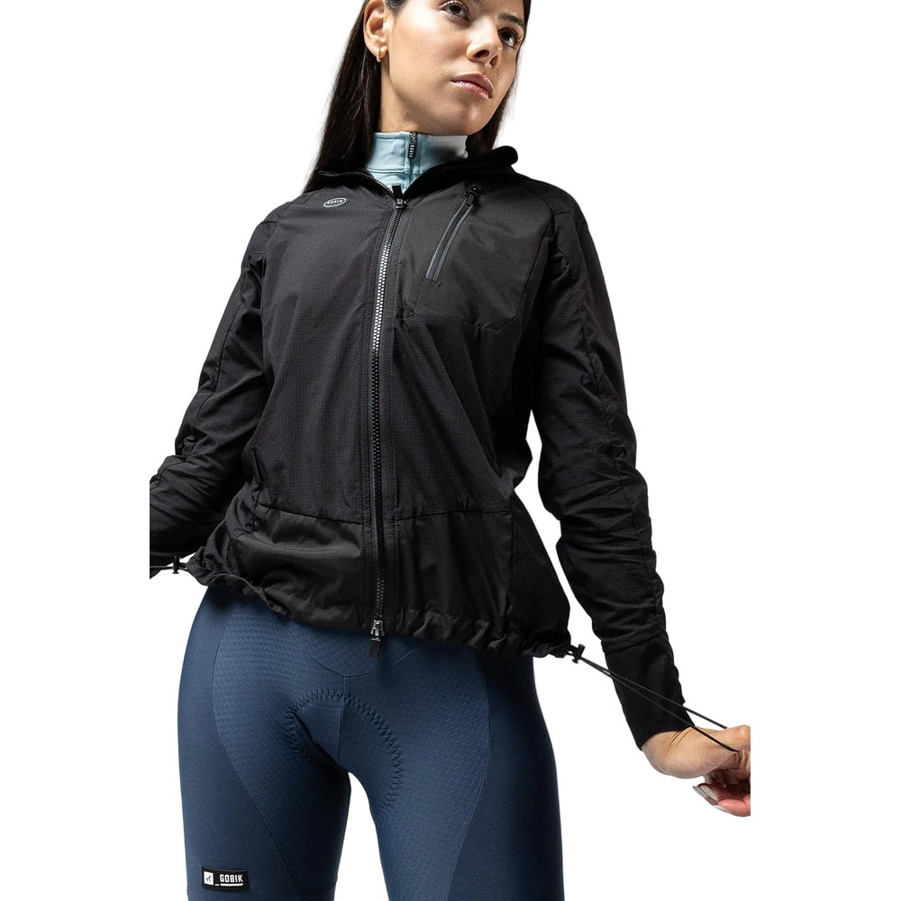 Woman wearing black Gobik lightweight rain jacket with blue cycling tights