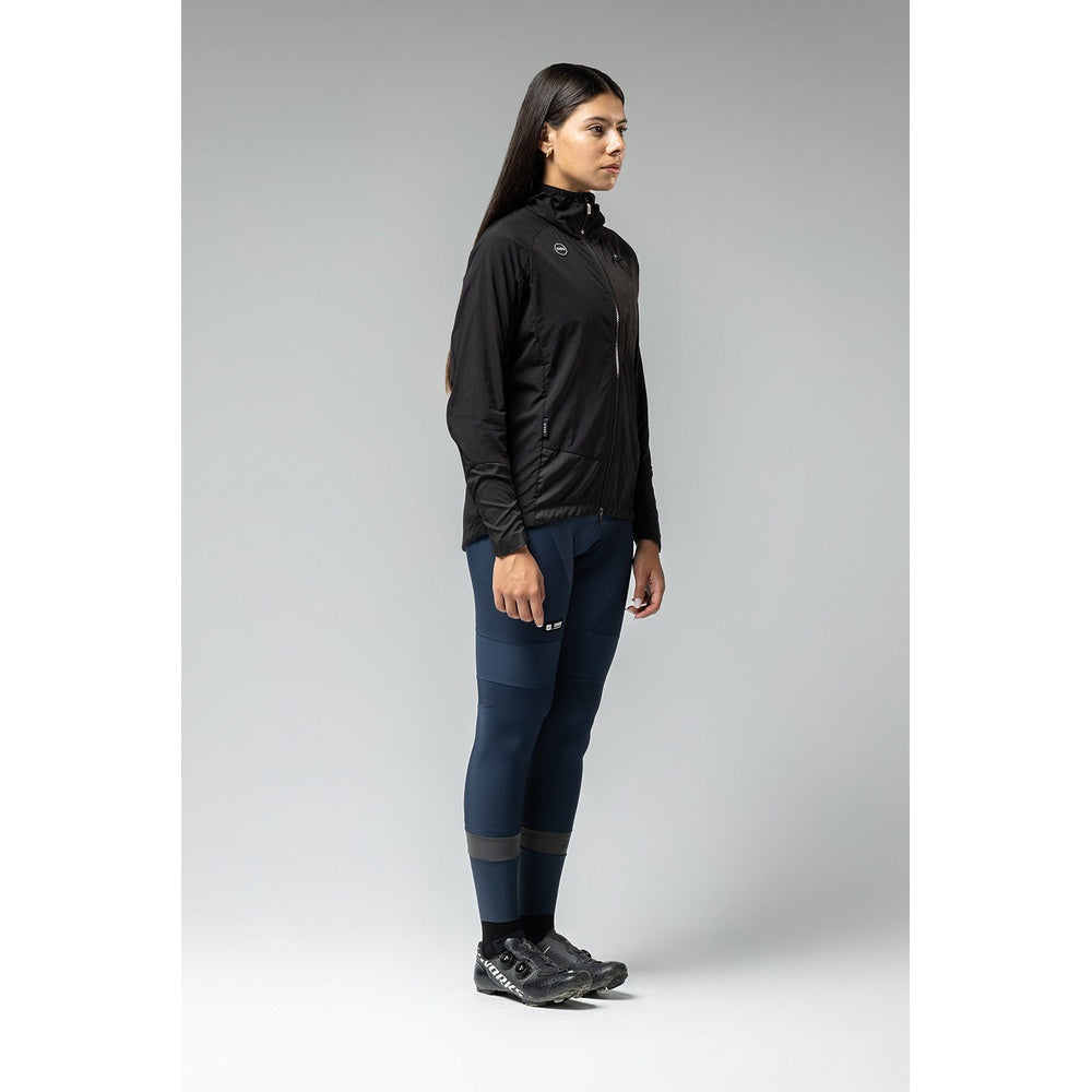 Woman wearing black Gobik lightweight rain jacket with navy blue cycling tights