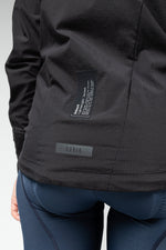 Gobik women's lightweight rain jacket in dark gray showing interior pocket details