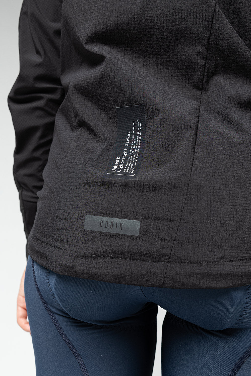 Gobik women's lightweight rain jacket in dark gray showing interior pocket details