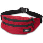 Red Dakine hip pack with crosshatch pattern and black zippers on white background