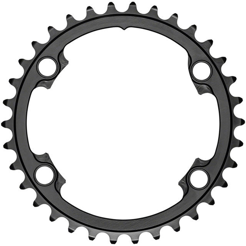 Black bicycle chainring with teeth and four bolt holes on white background