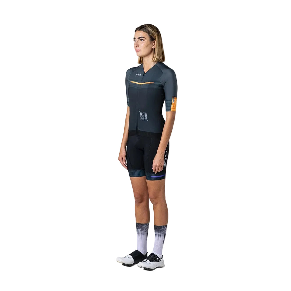 Woman wearing Gobik CX Pro cycling jersey in dark navy with orange details