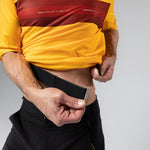 Gobik Volt cycling shirt in yellow and red Spectra colorway on model