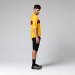 Man wearing yellow Gobik Volt short sleeve cycling shirt with red details