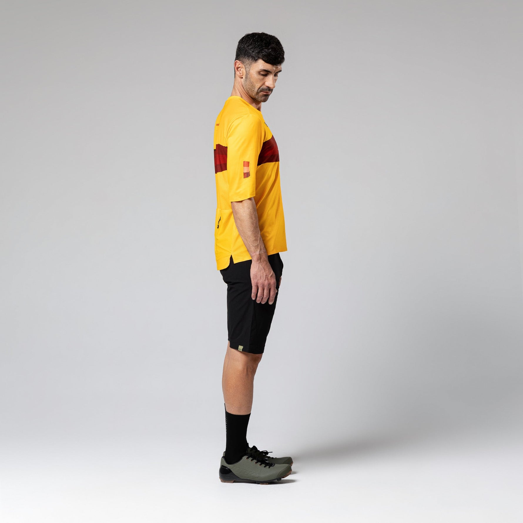 Man wearing yellow Gobik Volt short sleeve cycling shirt with red details