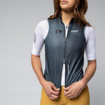Woman wearing Gobik Plus 2.0 cycling vest in meteor gray with white base layer