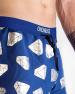Blue ChicknLegs men's shorts with white diamond geometric pattern on model