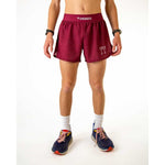 Man wearing ChicknLegs maroon athletic shorts with brand logo and split hem design