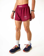 Man wearing ChicknLegs maroon athletic shorts with split sides and brand logo