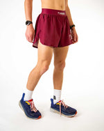 Woman wearing maroon ChicknLegs athletic running shorts with side splits