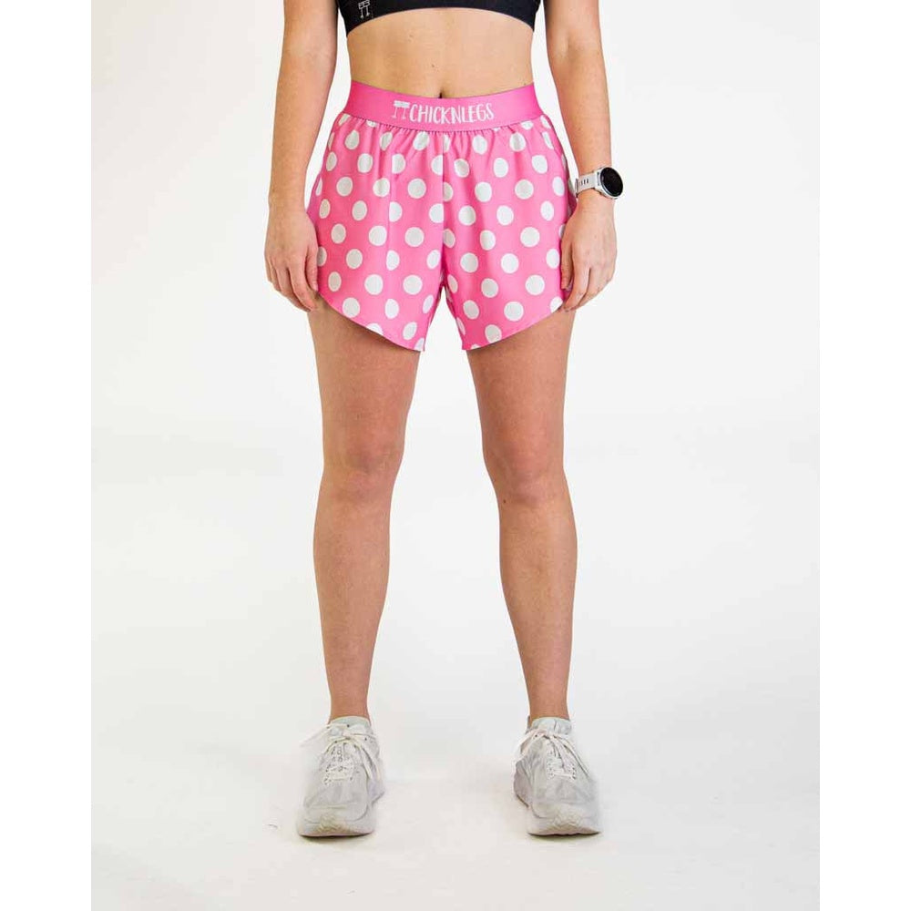 Woman wearing pink polka dot athletic shorts with ChicknLegs waistband