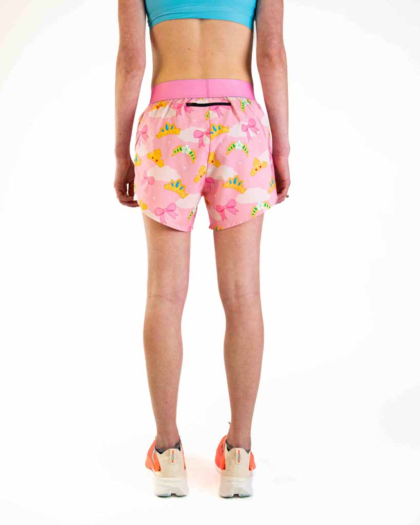 Woman wearing pink split shorts with princess tiara pattern, back view