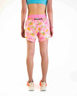 Pink split shorts with colorful princess tiara pattern worn by model