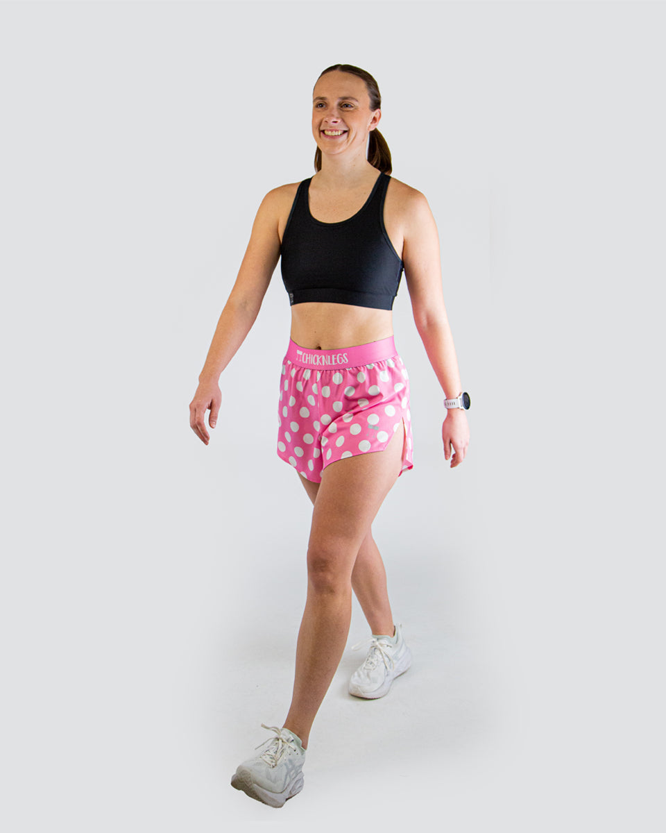 Woman wearing ChicknLegs pink polka dot running shorts with black sports bra