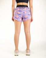 Purple athletic shorts with cute pink pig pattern, back view on model