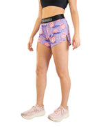 Woman wearing purple ChicknLegs split shorts with pink pig pattern and black waistband