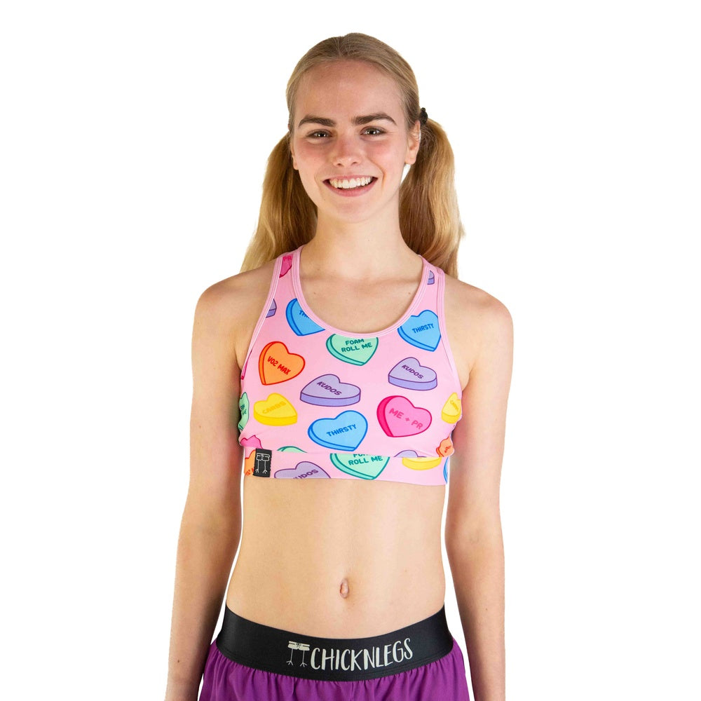 ChicknLegs Candy Hearts sports bra in pink with colorful conversation heart print