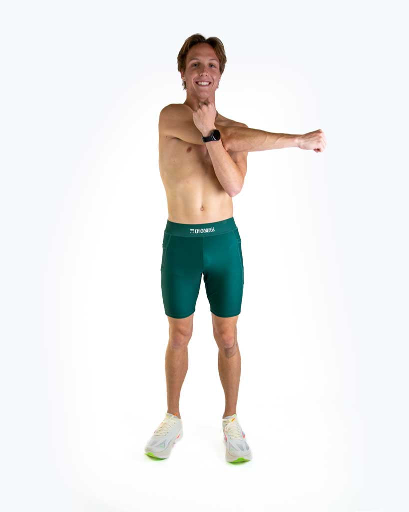Man wearing ChicknLegs forest green compression shorts in studio photo