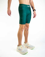 Man wearing ChicknLegs forest green athletic shorts with compression fit and side pocket