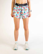 ChicknLegs women's athletic shorts with pink pig pattern on light blue background