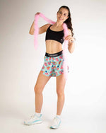 Woman wearing ChicknLegs Piggies 4-inch split shorts in mint blue with pig print pattern