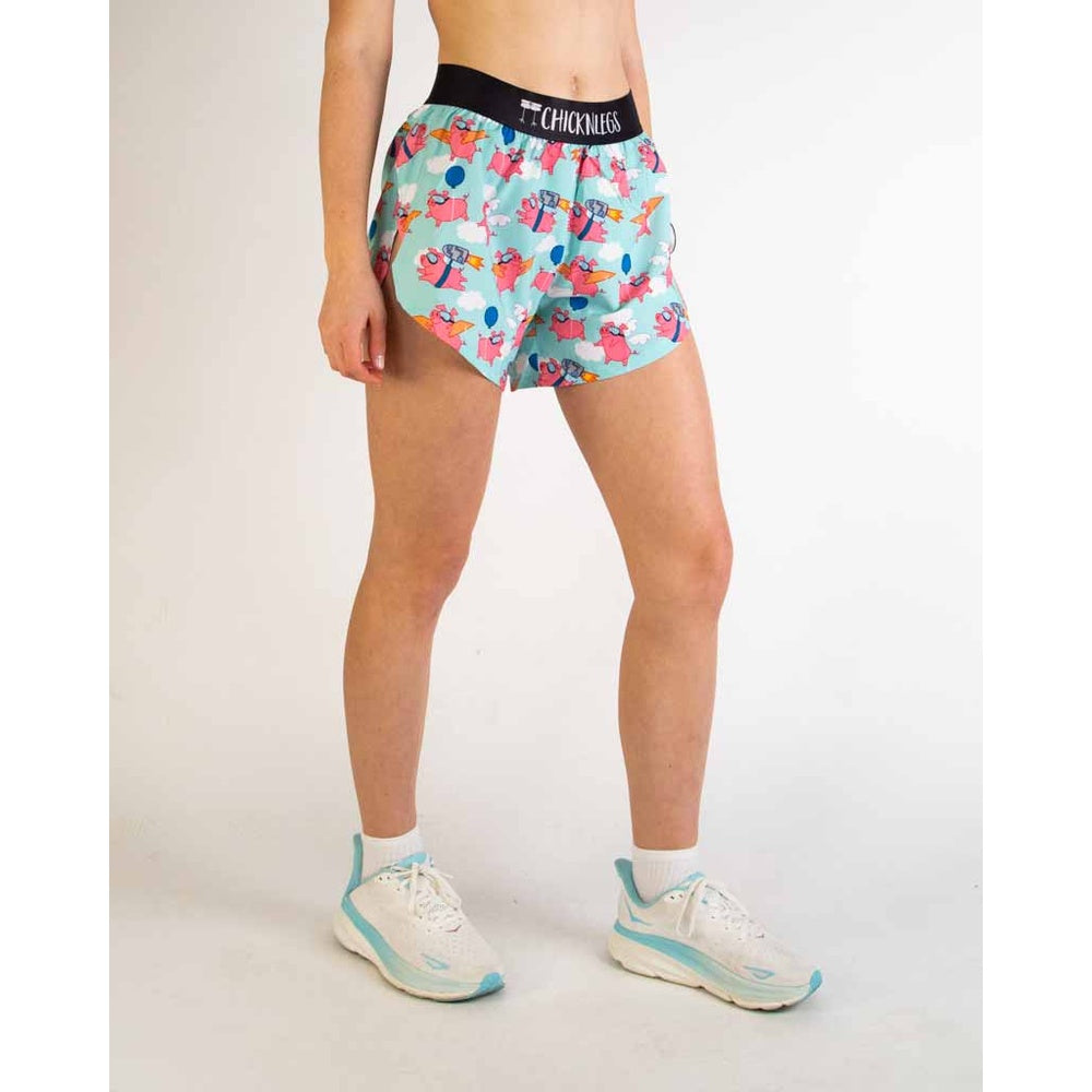 Woman wearing ChicknLegs Piggies 4-inch split shorts in light blue with pink pig print