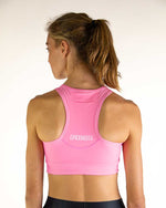 Back view of woman wearing pink ChicknLegs racerback sports bra with brand logo