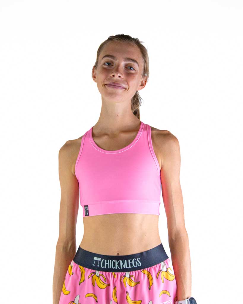 Woman wearing ChicknLegs bubblegum pink sports bra and banana print shorts