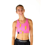Young woman wearing pink sports bra with yellow lightning bolts and black shorts