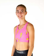 Woman wearing pink sports bra with yellow lightning bolt pattern