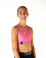 Woman wearing ChicknLegs bubblegum pink sports bra with yellow lightning bolt print