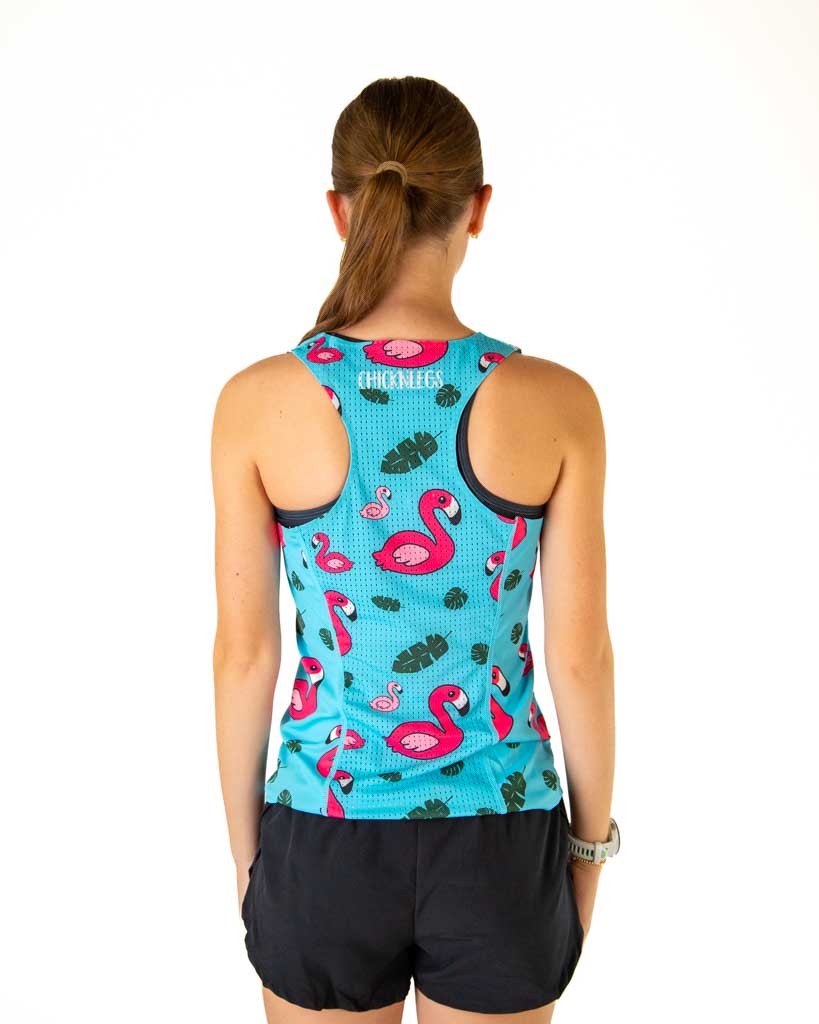 Back view of woman wearing turquoise athletic singlet with pink flamingo pattern