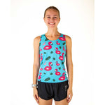 Woman wearing turquoise blue athletic tank top with pink flamingo pattern and black shorts