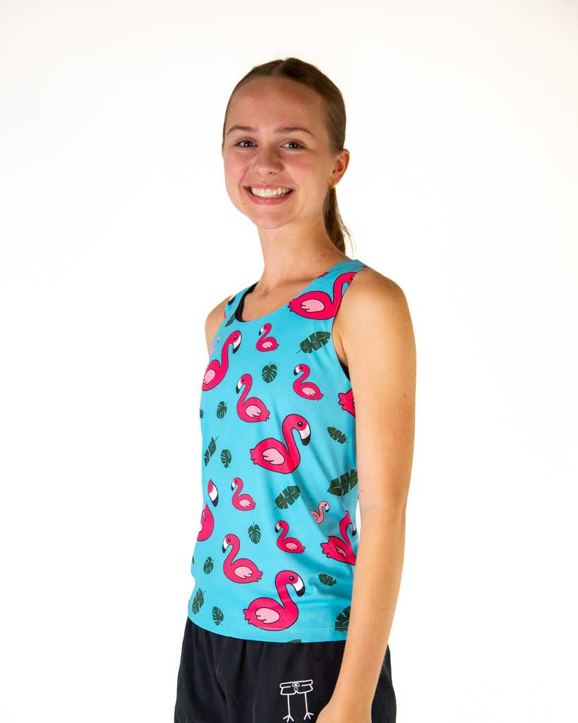 Woman wearing turquoise blue tank top with pink flamingo and tropical leaf print