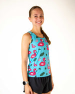 Woman wearing turquoise blue athletic tank top with pink flamingo pattern