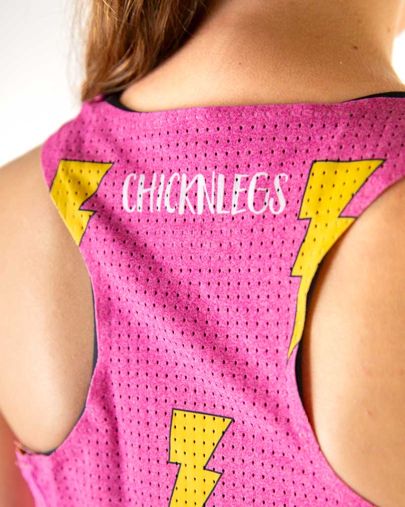 Back view of pink performance singlet with yellow lightning bolts and ChicknLegs branding