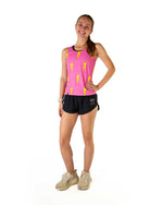 Woman wearing pink tank top with yellow lightning bolt pattern and black shorts