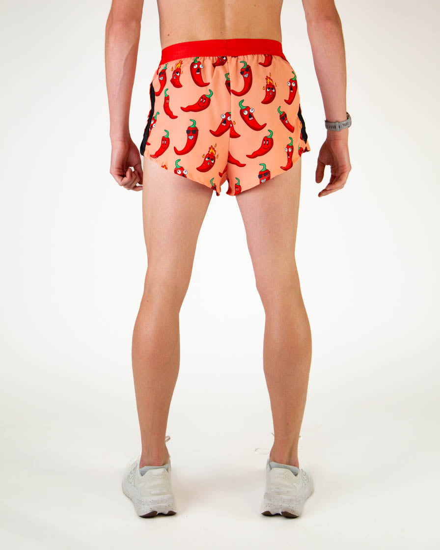 ChicknLegs men's split running shorts with red chili pepper print on pink background