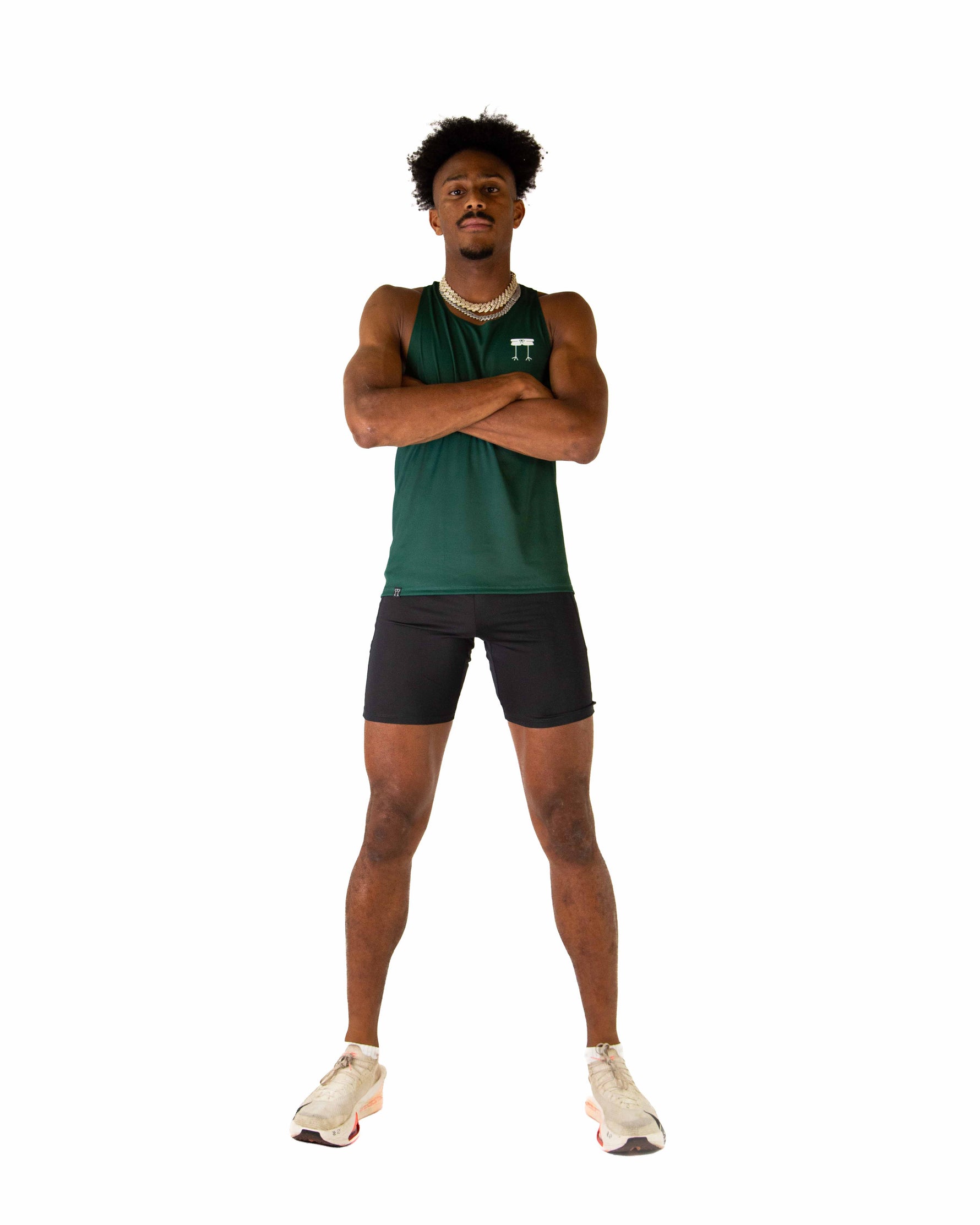 Athletic man wearing forest green performance singlet tank top with crossed arms