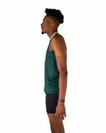 Man wearing forest green performance tank top in studio photo