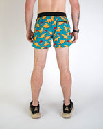 ChicknLegs men's 4-inch running shorts with chicken nuggets print on turquoise background