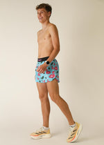 Man wearing light blue shorts with pink flamingo print pattern
