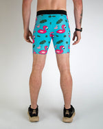 Men wearing turquoise blue compression shorts with pink flamingo and tropical leaf pattern