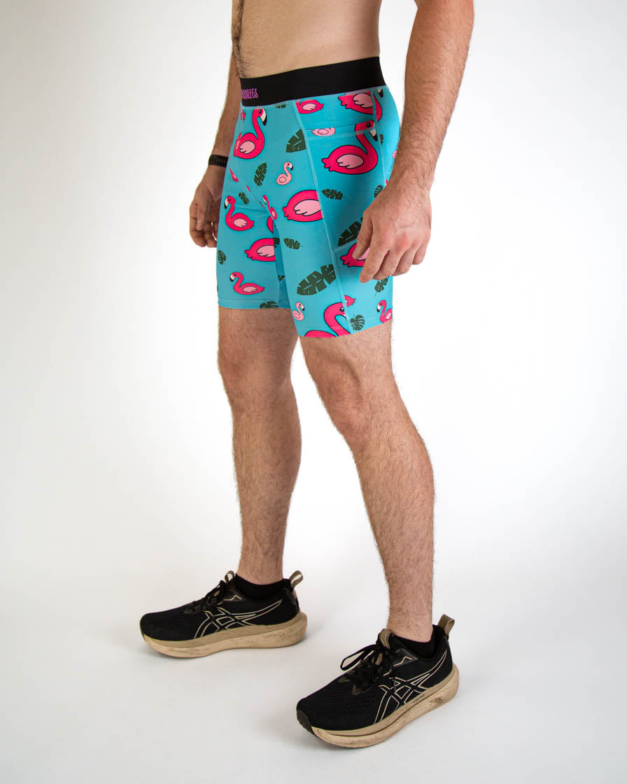 Man wearing turquoise blue half tights with pink flamingo pattern and black waistband