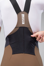 Gobik Grit bib shorts in toffee brown and black worn by cyclist
