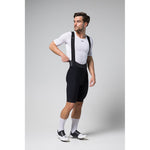 Male cyclist wearing black Gobik Limited 6.0 bib shorts with white jersey